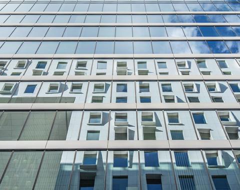 skyscraper windows reflecting another building